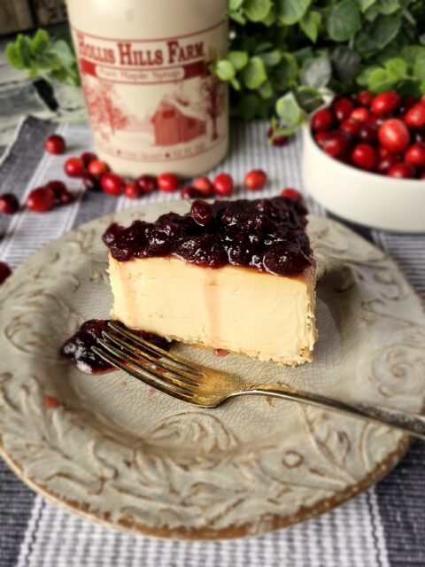 A slice of New York stylecheesecake with cranberry topping